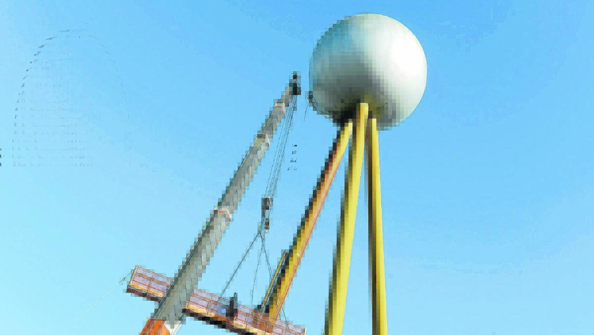 Crane operators remove badly rusted water pipes from the Fletcher Jones ball. 