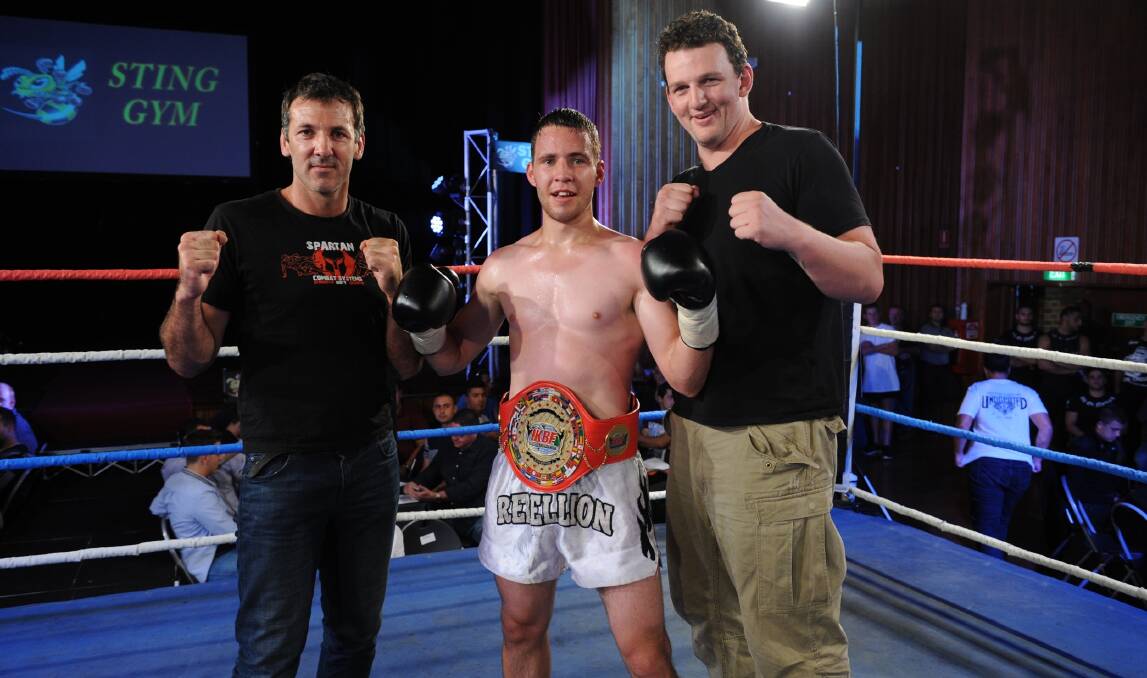Warrnambool’s Lachlan Dart with coach David Gibb (left) and Traill Dowie after his win at Springvale. Picture: Terry Vorg, www.kickboxing.com.au