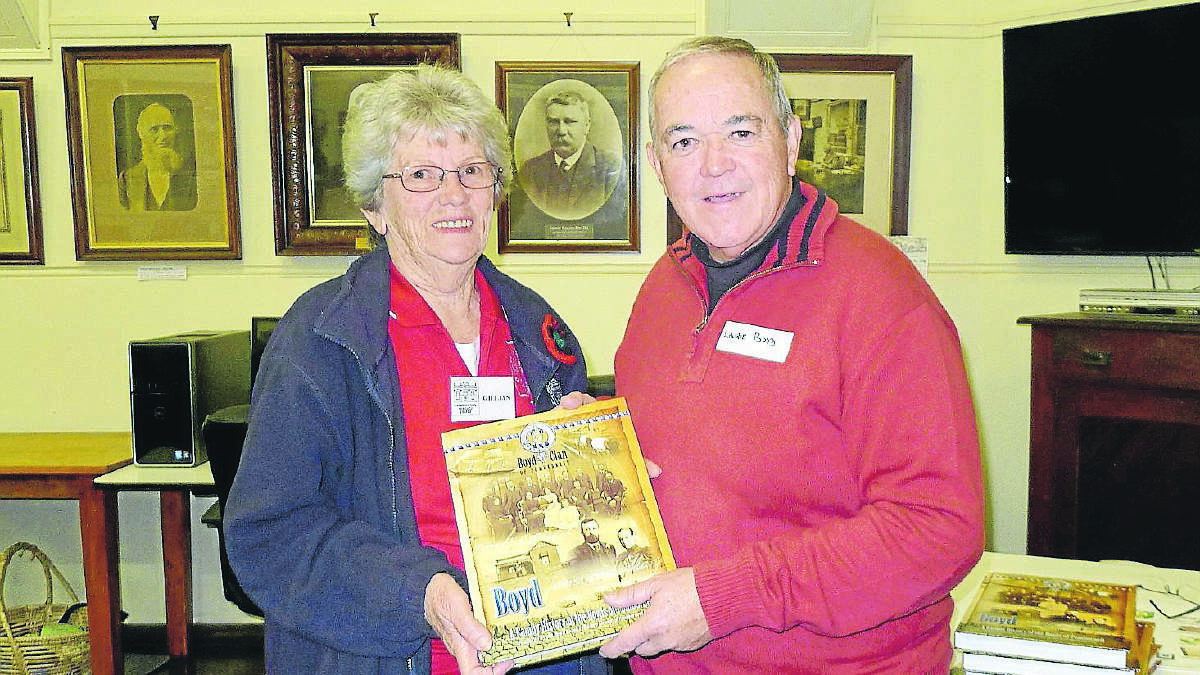 Laurie Boyd presents a copy of the book Boyd - A Family History of the Boyds of Pomborneit to Camperdown and District Historical Society president Gillian Wadds.Photo: Supplied