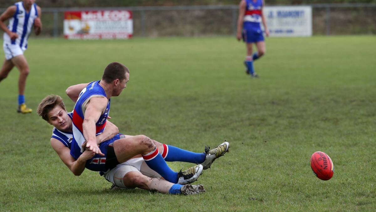 Panmure’s Tom White releases the ball in a tackle from his Russells Creek opponent Cameron Finlayson. 