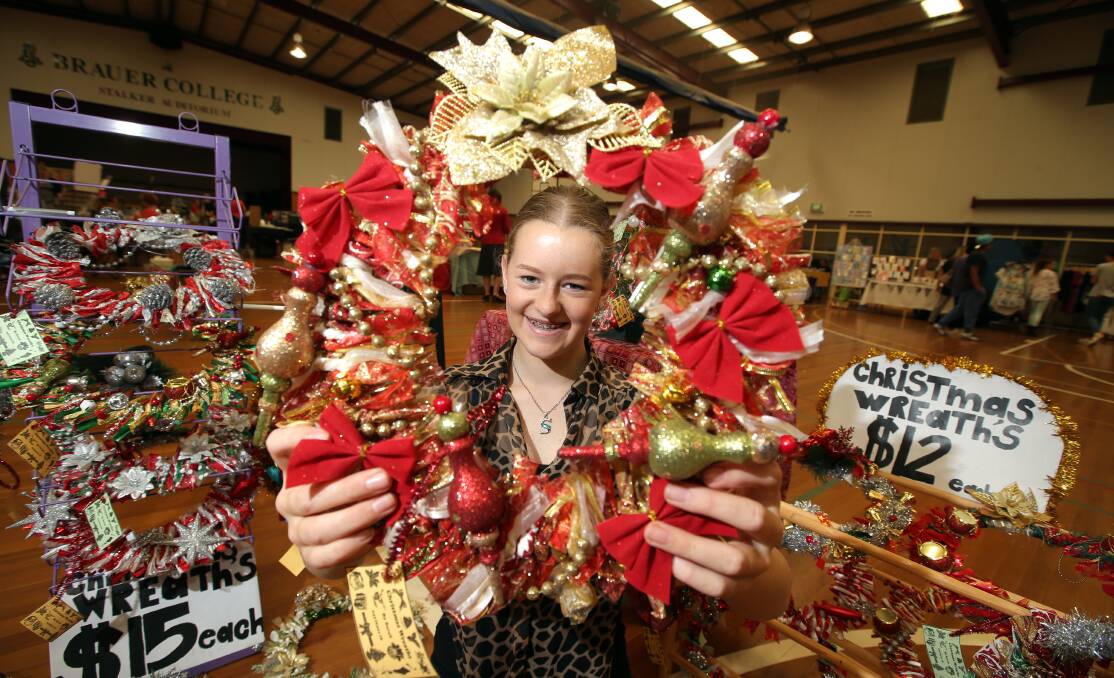 Student Sarah Hancocks, 14, sells her Christmas wreaths at the Brauer College Christmas Gala Market. 141123DW06 Picture: DAMIAN WHITE