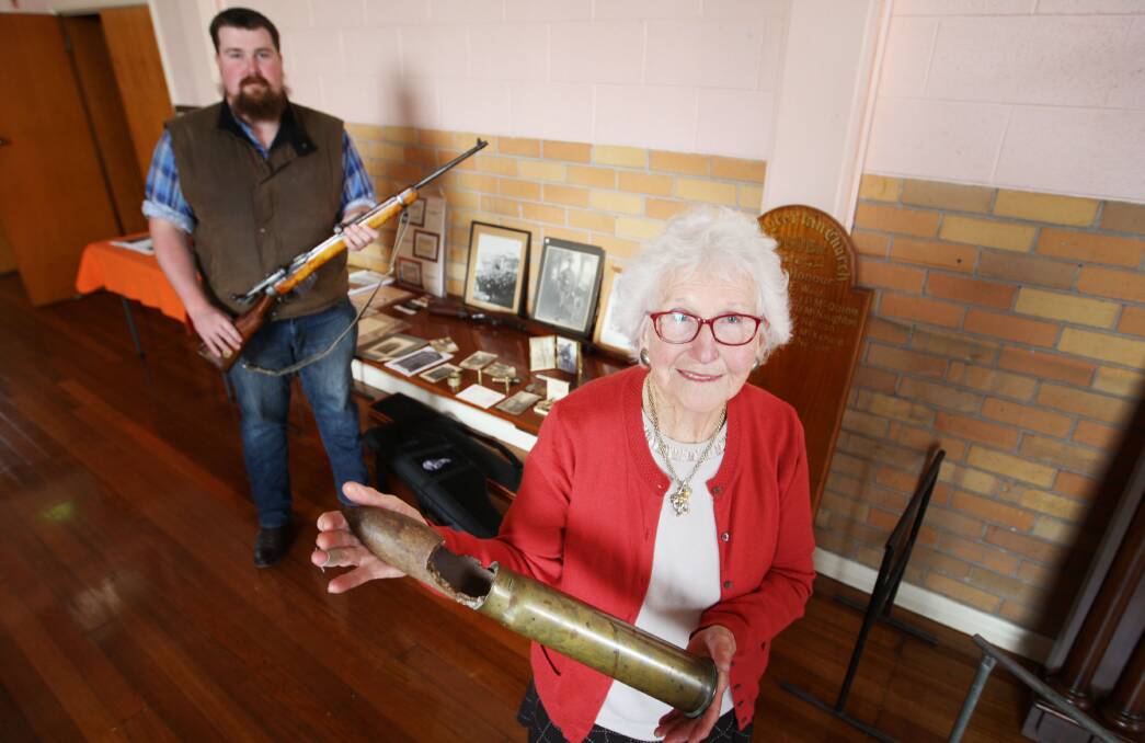 Callum Meade, holding a customised Lee Enfield rifle, and Alma MacDonald (right) at the Cobden Anzac exhibition.           
150417AM01 Picture: ANGELA MILNE