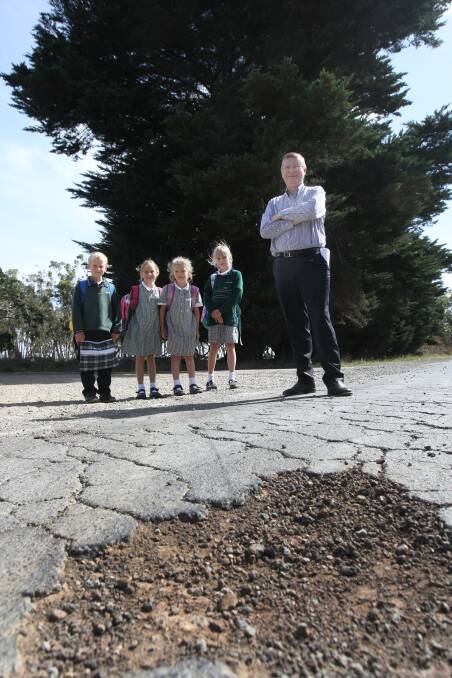 MP Denis Napthine inspects the crumbling Macarthur-Myamyn Road with Jack Addinsall (left), 9, Zoe Addinsall, 7, Tabitha Dettling, 7, and Clara Dettling, 9. 150305AS13Picture: AARON SAWALL