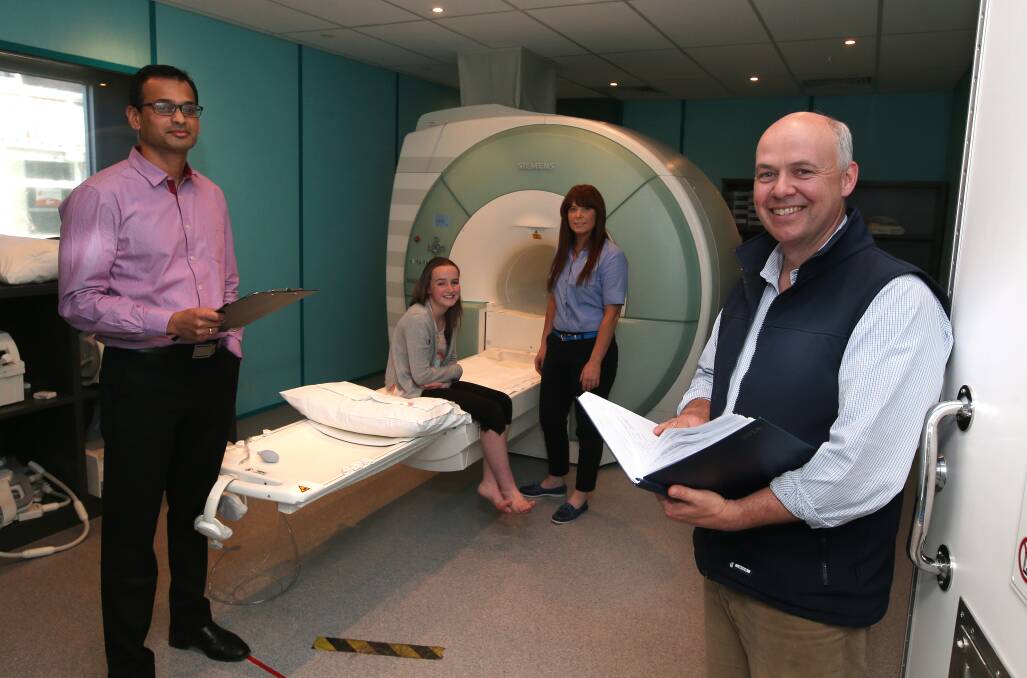 Healthcare Imaging Services radiologist Vijay Patheyar (left), MRI technician Tamika Kelson and South West Healthcare paediatrician Dr Christian Fiedler attend to with patient Isabel Rowan, 12, from Camperdown. 141008DW31 Picture: DAMIAN WHITE