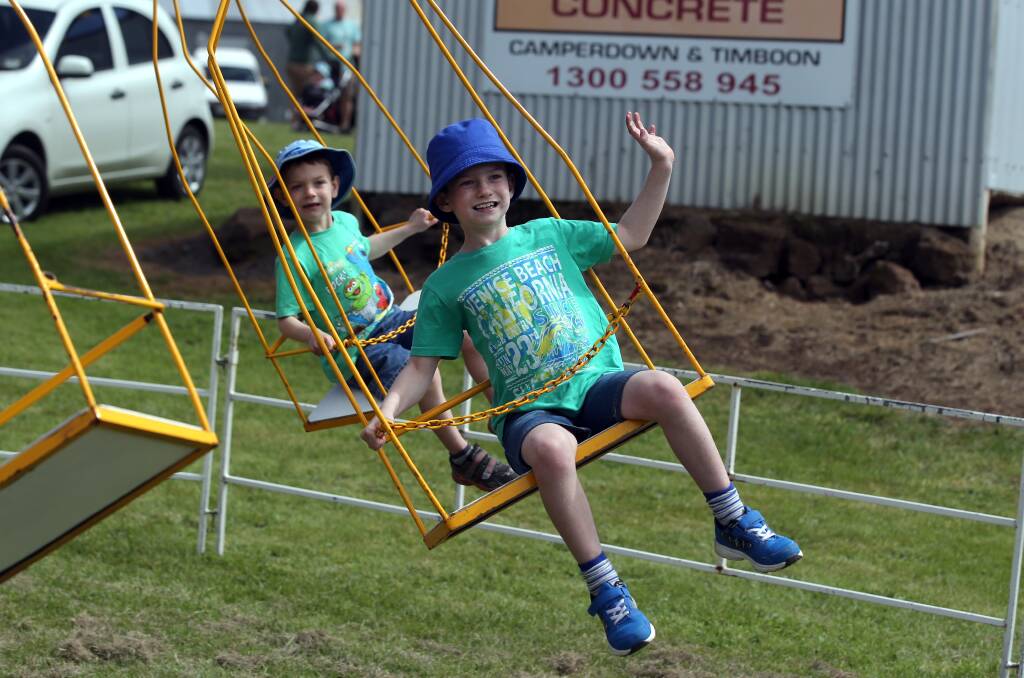 Charlie Hassett, 7, (front) and his brother Paddy, 5, from Camperdown, enjoy a ride on the Lions club merry-go-round. 141011DW42