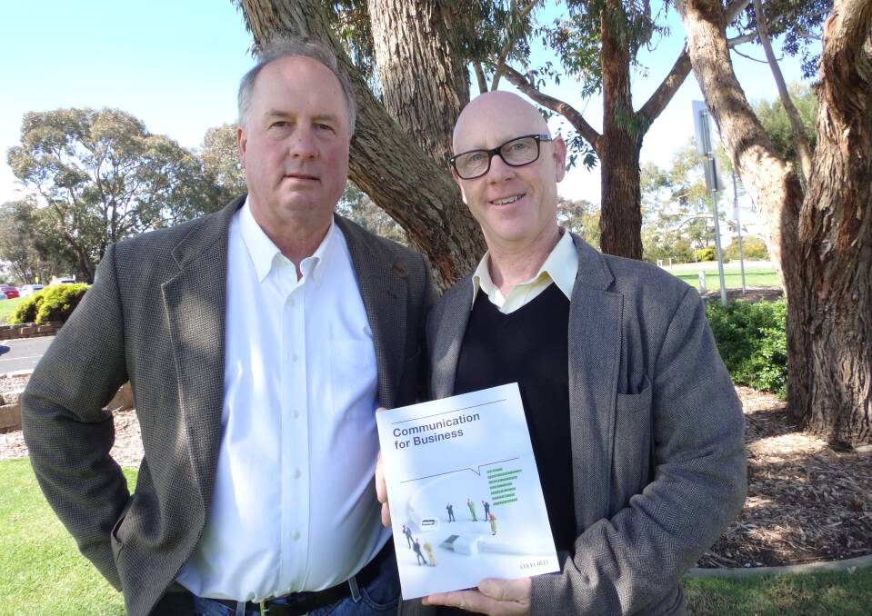 Warrnambool educators Don Swanson (left) and Dr Andrew Creed show off the textbook which won them a national recognition by the Australian Publishing Association.