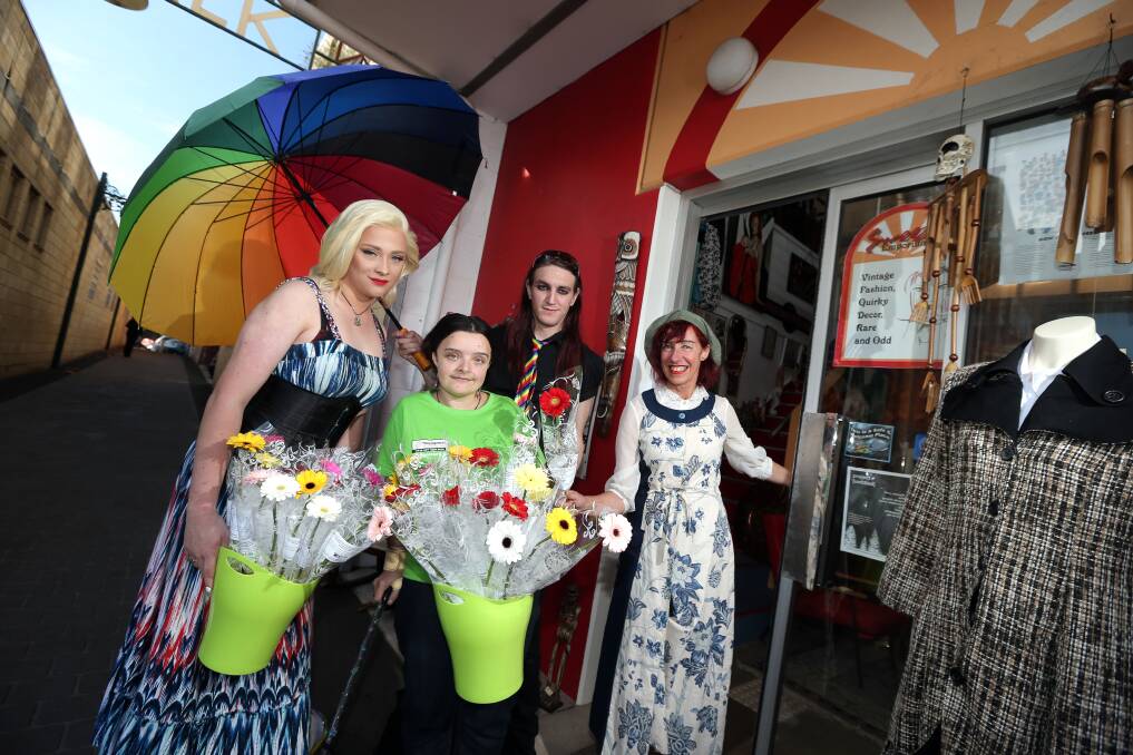 Aliza Willows (left), Laura Hawkins and  Shane Hernan hand a flower to Suzi Walter from Sweezy Emporium. 150518DW45
 Picture: DAMIAN WHITE