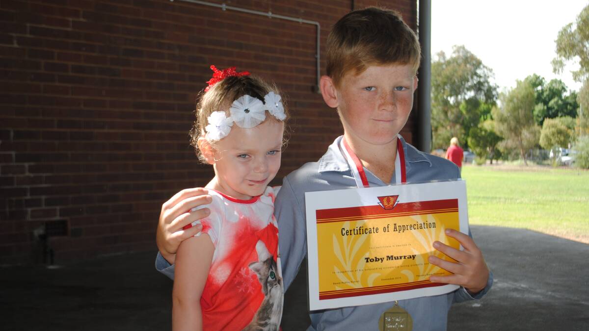  Ava Klemke of Henty puts her arm around Toby Murray, the young boy who saved her from drowning.