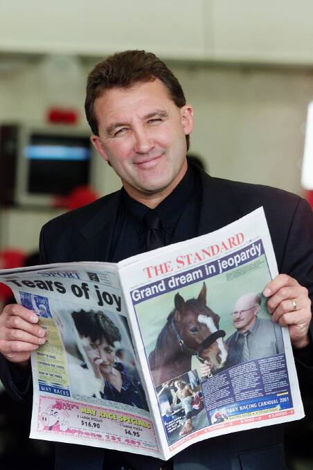 AFL personality Doug Hawkins catching up on all the May racing news in The Standard at the racetrack in 2001.