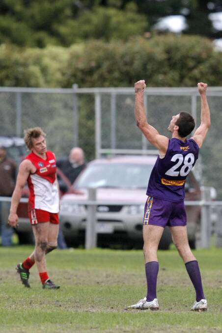 Sandy Robinson raises his arms in the air as the siren sounds, signalling Port Fairy's first win in two years. Picture: ROB GUNSTONE