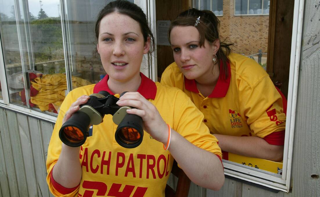 Warrnambool lifesavers Erin Pearson and Bridget Smith, both 15, keep watch from the surf club tower.