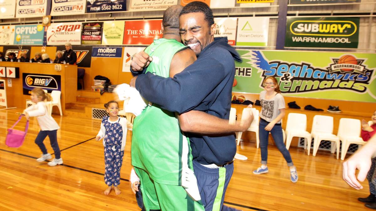 Tim Gainey and injured US import Sai'Quon Stone celebrate after the final buzzer.