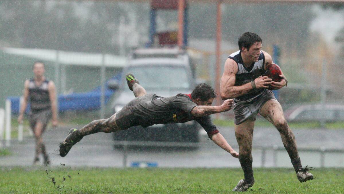 Timboon Demons player Simon Harkness was full stretch to tackle Allansford's Matthew Dwyer in WDFNL round 14 Matches. Picture: LEANNE PICKETT