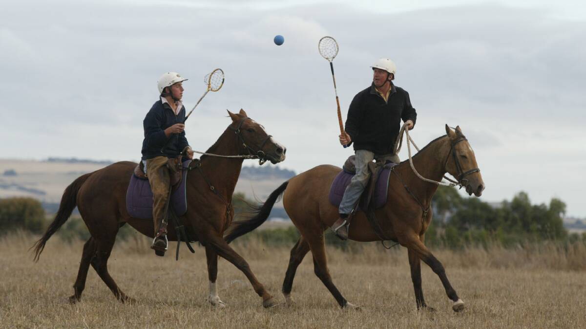 Tom McMahon, 14, and his dad - Jock, playing polo-crosse on the family farm near Camperdown.