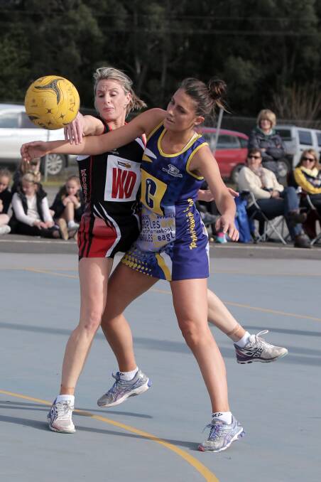 Koroit wing defence Kate Foster knocks the ball away from North Warrnambool's Maddison Smedts in a physical contest. Picture: ROB GUNSTONE