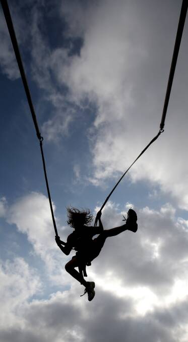 Sebe Hintum, 9, from Warrnambool takes a bounce with the bungee jump.