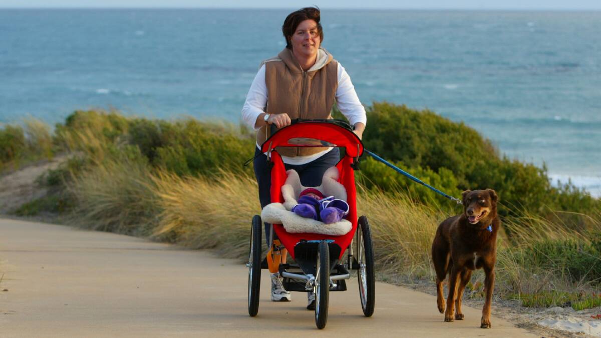 Sarah El-Hage with daughter Lucy, four months and Kippa the dog walking along the foreshore.