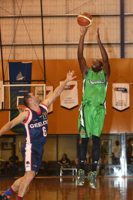 Seahawks forward Tim Gainey shoots over Supercats defender Steve Wiasak. Picture: DAMIAN WHITE