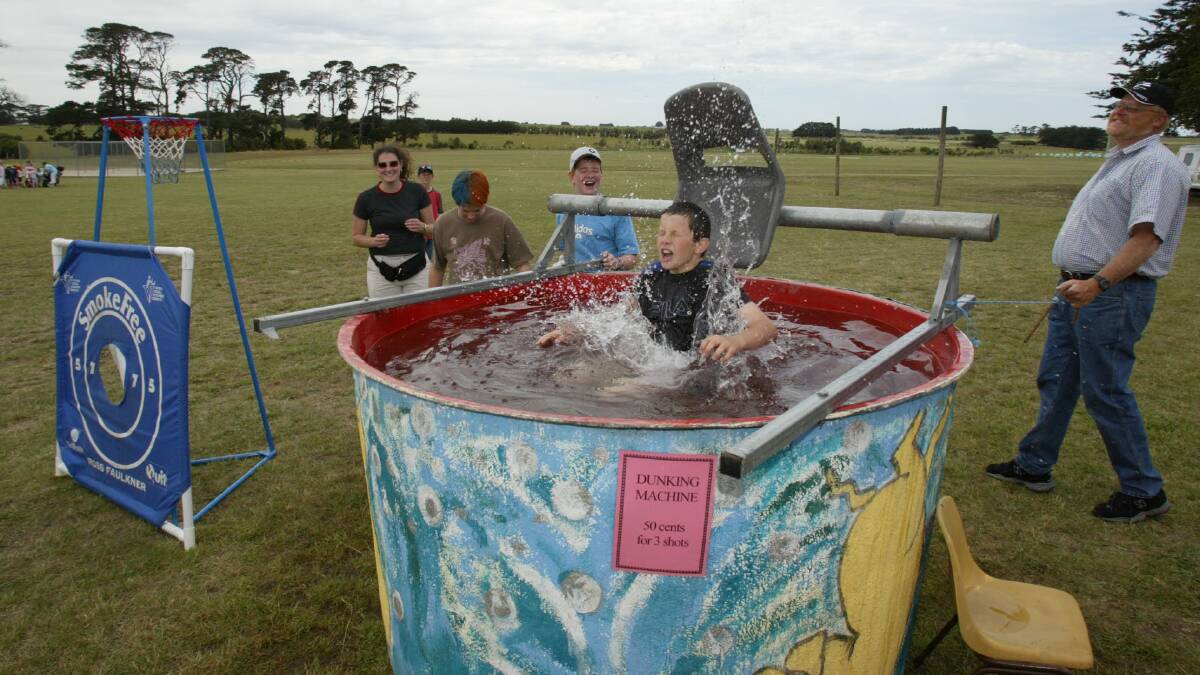 Lucky dip: Andrew Agnew takes an unexpected tumble into the dunking machine at the King's College fete.