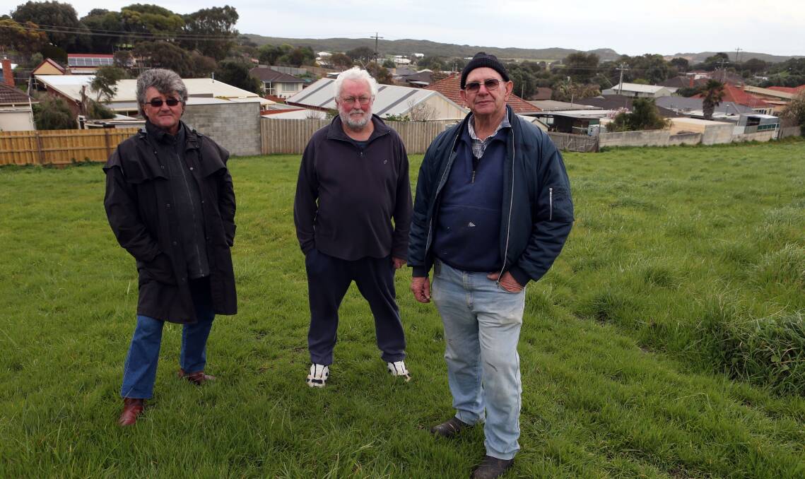 Merrivale residents David Donaldson, Geoff Wilson and Norm Sheppard on land backing onto Merrivale Drive where industrial sheds could be built. Picture:LEANNE PICKETT