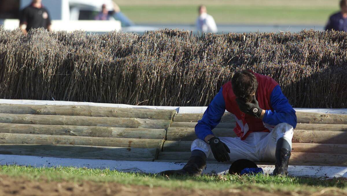 High Celebrity jockey John Macmillan after his fall over the first Tozer Road jump on the second lap of the steeplechase.