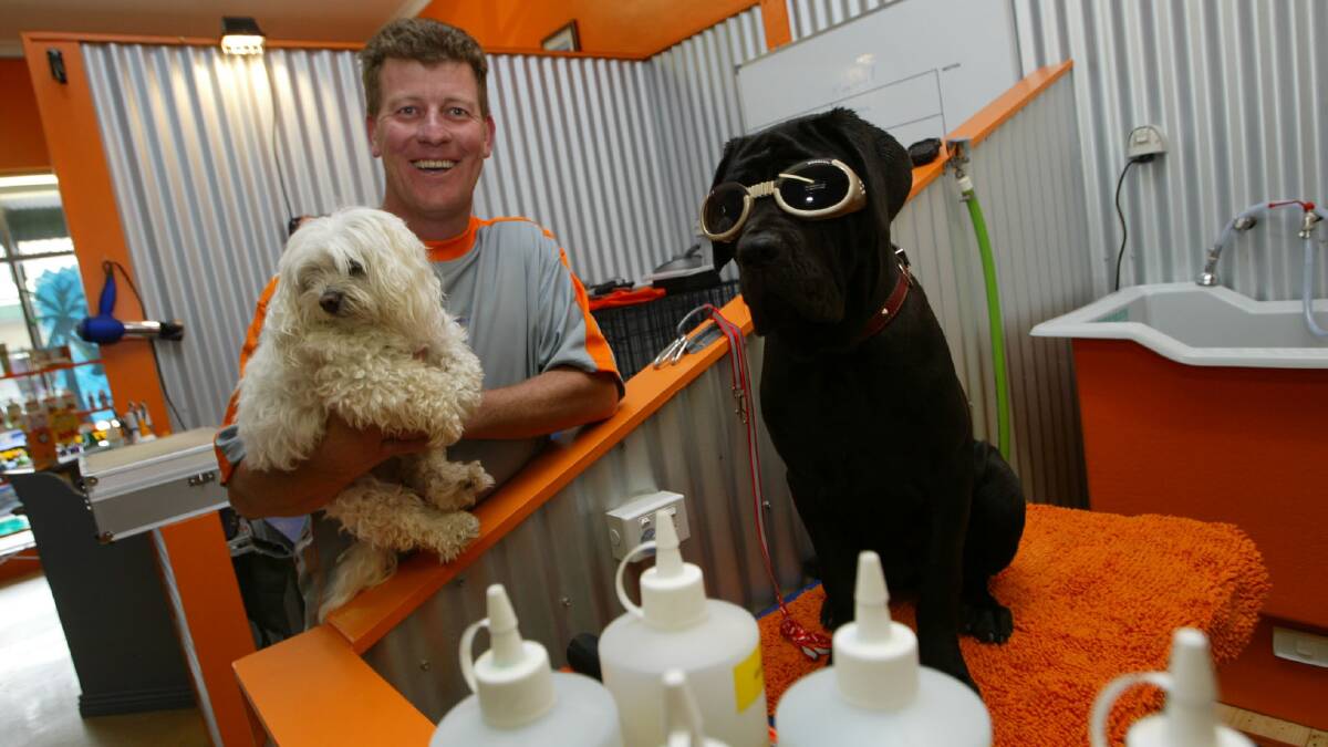 Mark Sharkey has opened new dog grooming business called Pooch Paradise in Fairy Street, pictured with his dog Henri and a client's dog Lucy.