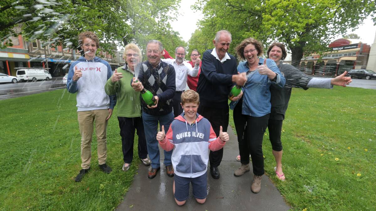 Cooking with gas: Veteran gas campaigner Jim O’Brien (centre, right) pops the champagne during an impromptu celebration with (from left) Harry Cook, 15, Pat Lee, fellow champagne sprayer Kevin Lee, Grant Picone, Anne Cook, Sandra Noonan, Melissa Richardson and (front) Lochie Cook, 14. Picture: VICKY HUGHSON