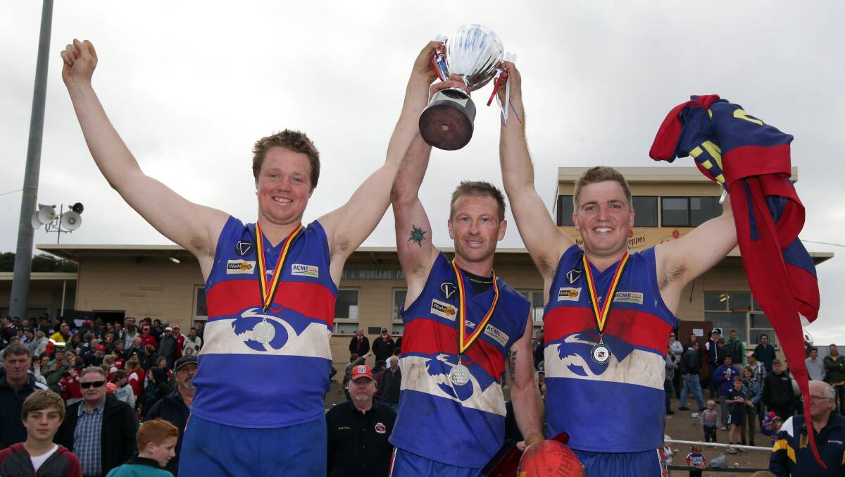 Panmure coach Simon O'Keefe (centre) and joint captains Chris Bant (left) and Sam Mahony celebrated their WDFNL flag victory. Picture: DAMIAN WHITE