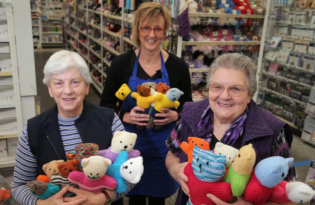 Red Cross volunteer Lorraine Steff, Spotlight's Anne-Maree Cook, and Red Cross volunteer Phyllis Vaughan with some of the trauma teddies knitted for children. Picture: ROB GUNSTONE