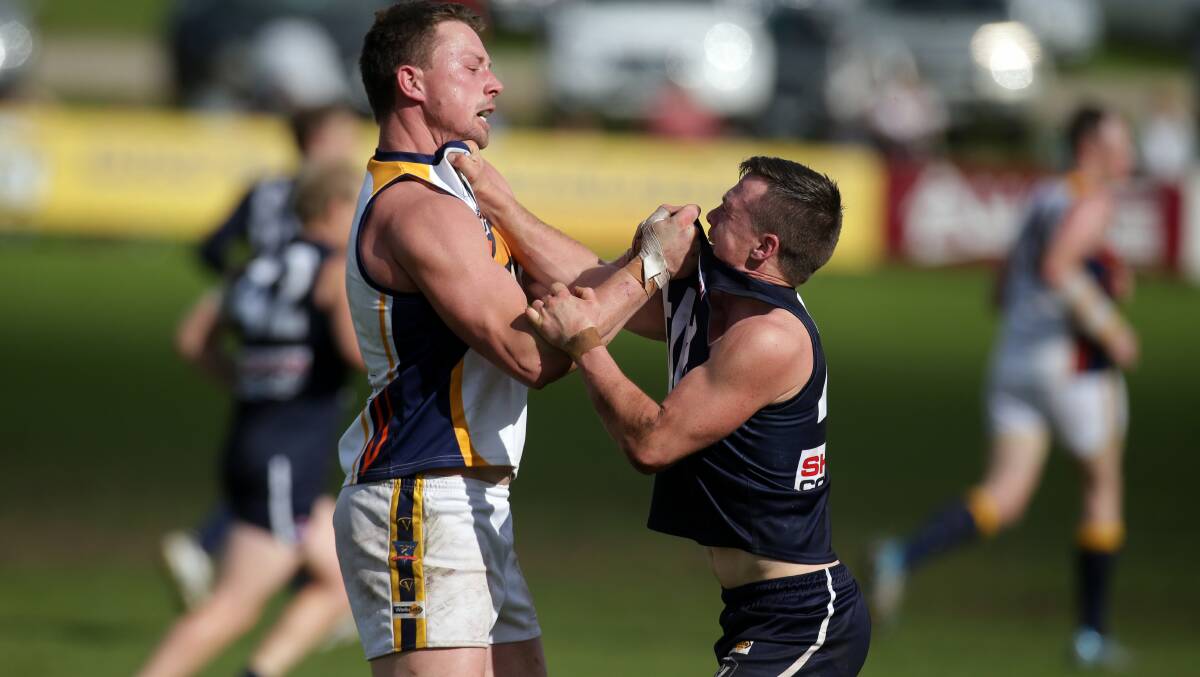 Warrnambool player Angus Chirnside and North Warrnambool Eagle's David Haynes having a wrestle. Picture: DAMIAN WHITE 