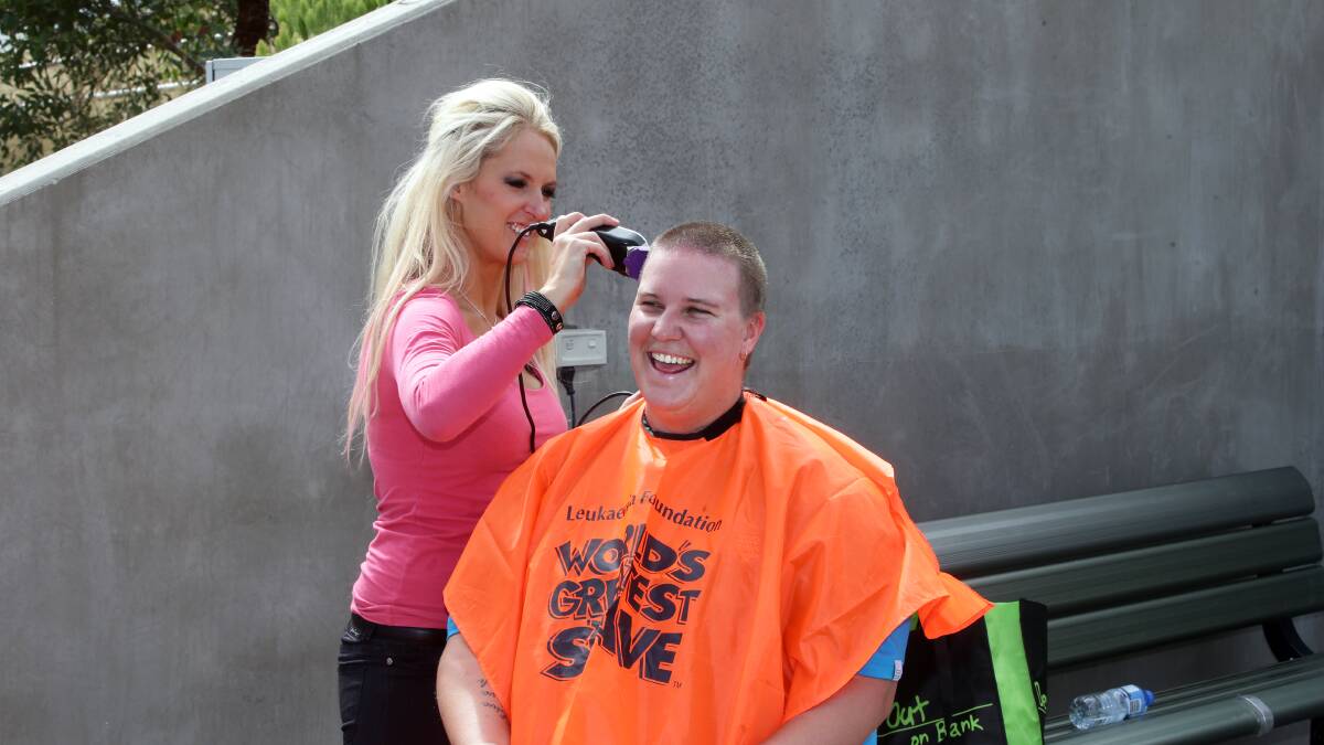 Hairdresser Sally McCosh shaves Lisa Smith's head.