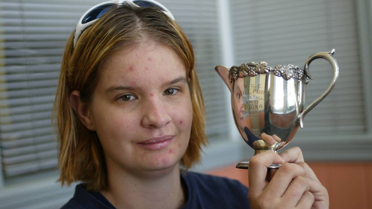 Susanne King and her father's Gill Cup golfing trophy. 