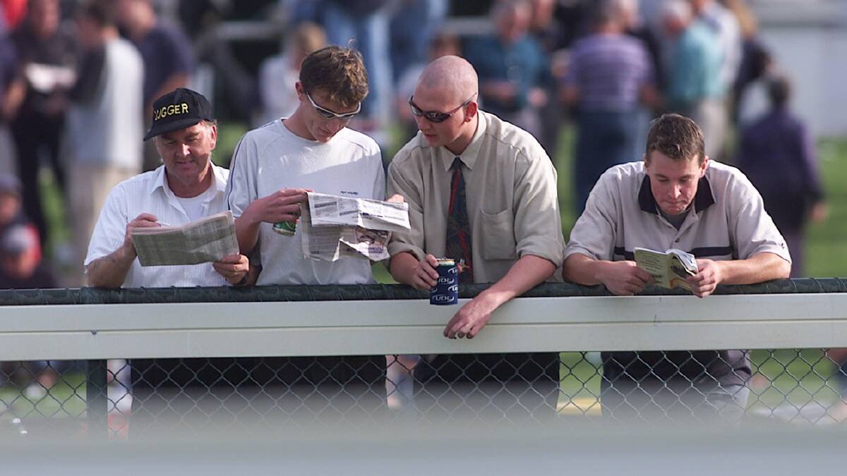 Ray Tyzack, Matthew Howe, Damian Clark and Derek White, all from Warrnambool, checking their race guide in 2000.