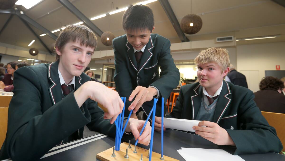 Brauer College year 10 students Liam Glare, 16, Victor Mou, 16, and Joe Leighton, 16, working hard on one of the challenges. 