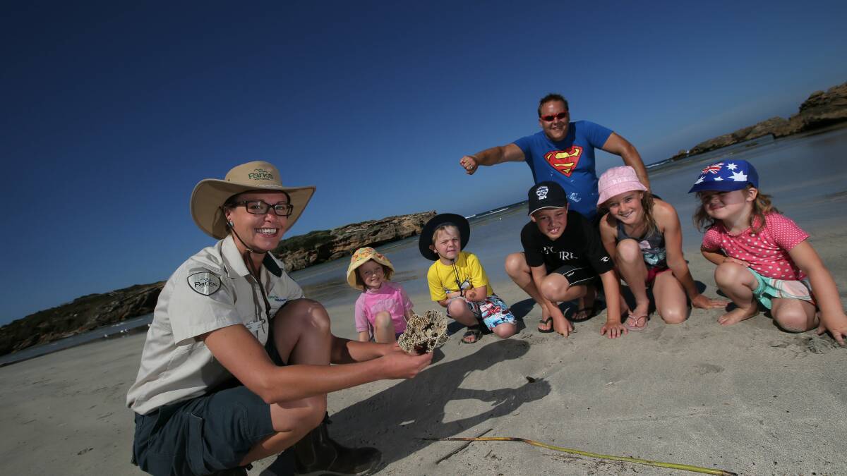 Erica Connell, 5, Darby Walsh, 6, Alex Johnston, 8, Wilhelm Stroja, Amy Johnston, 9, and Edith Walsh, 3, explore Merri Marine Sanctuary last summer with help from summer marine ranger Danni Rizzo (left).   