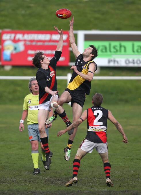HIGH JUMP: East Warrnambool's Jordan Collins and Merrivale's Jack Grace leap for the ball in a ruck contest on Saturday. Picture: Amy Paton