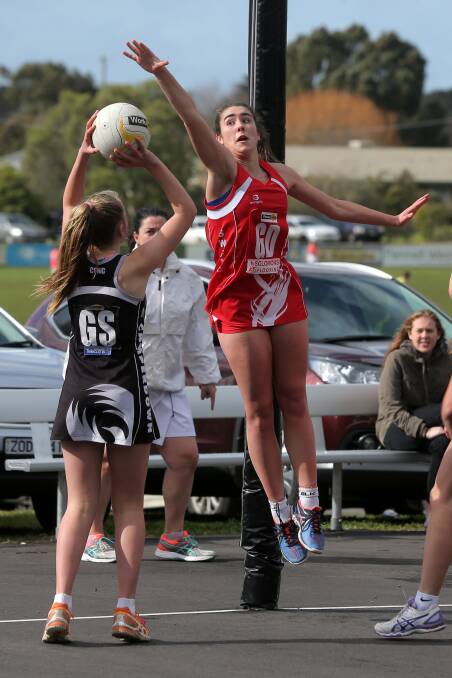 TAKING AIM: Camperdown goal shooter Krystal Baker holds her shot as South Warrnambool goal defence Ally O'Connor jumps high. Picture: Rob Gunstone