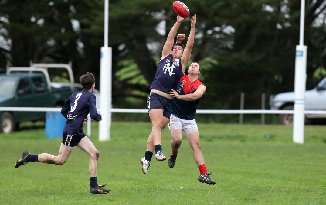 Nirranda's Rick Spokes flies for a mark in front of Timboon Demons player Brad Hallyburton. Picture: Rob Gunstone