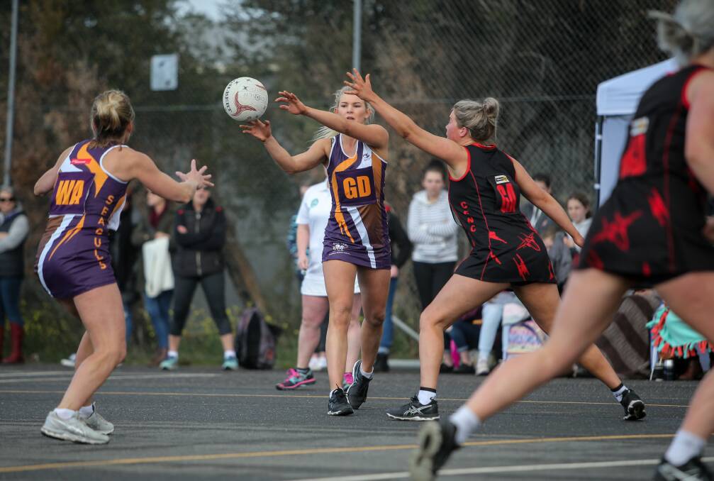 FINDING A WAY: Port Fairy goal defence Carly Watson passes the ball to teammate Nicole Dwyer. Picture: Christine Ansorge