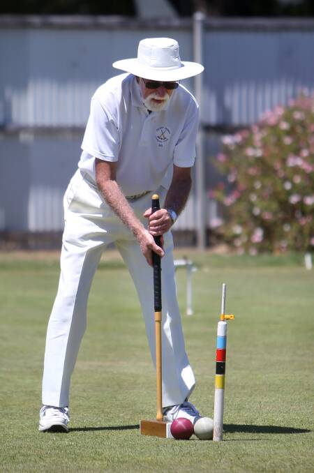 CONCENTRATION: Bill Humphrey of Golden Square Croquet Club lines up a shot during the Warrnambool Croquet Club annual summer tournament. Picture: Amy Paton