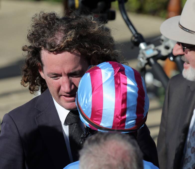 Ciaron Maher in discussion with a jockey at Warrnambool's May Racing Carnival.