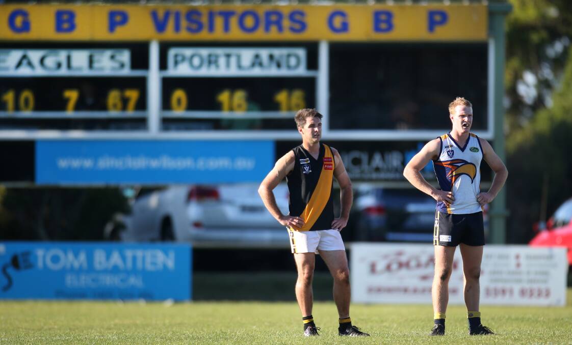 LOPSIDED: Tiger Trent Johnston and Eagle Luke Wines in front of a less-than-flattering scoreboard for Portland on Saturday. Picture: Amy Paton