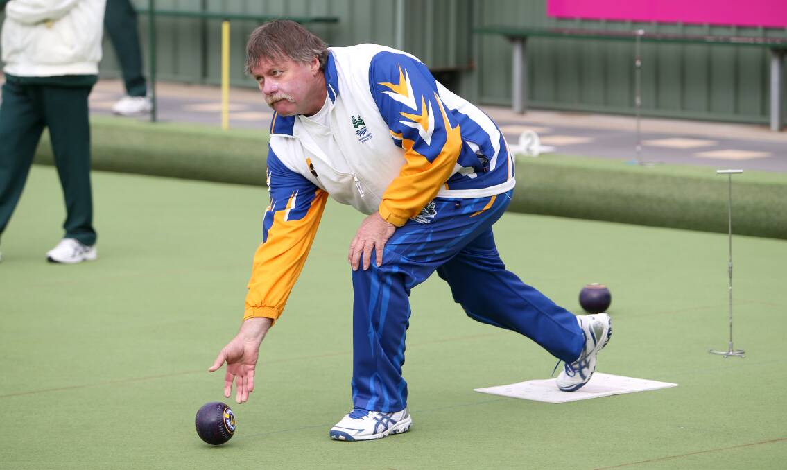 STEPPING FORWARD: Warrnambool White skipper Ian Hatfield sends a bowl down the green against City Memorial Gold on Saturday. Pictures: Amy Paton