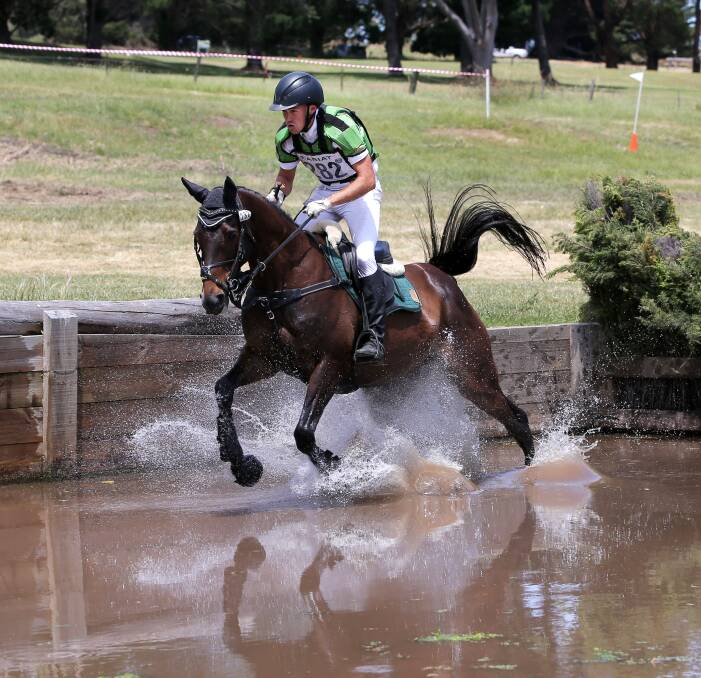 MAKING A SPLASH: Benjamin Tyson, riding Chilli Class, make his way cleanly over the jump and blasts through the water at Camperdown's Lakes Sporting Complex on Saturday. Picture: Rob Gunstone