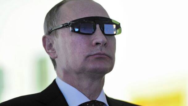 Russian President Vladimir Putin wears special glasses at a research facility in St Petersburg Photo: AP