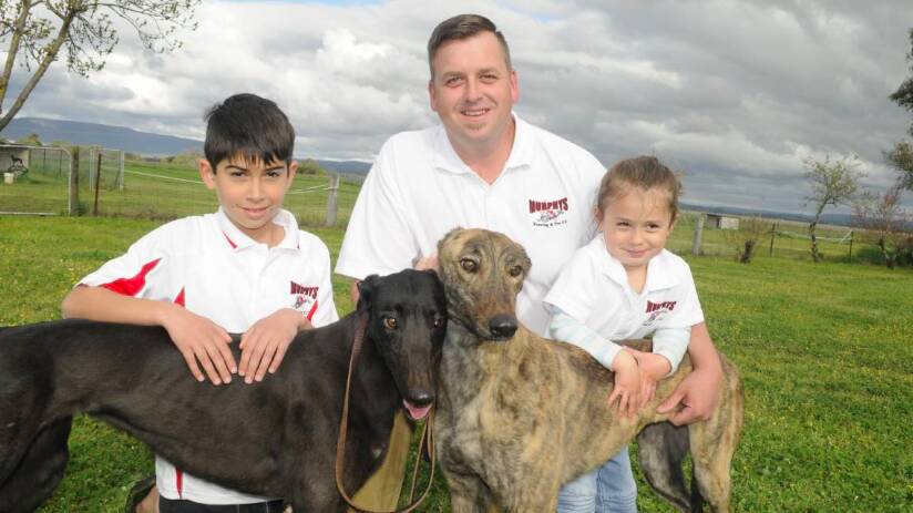 Matt Murphy and his children Kyle, 9, and Khali, 3, with greyhounds Annabelle and Jo Jo. Photo: CHRIS SEABROOK 