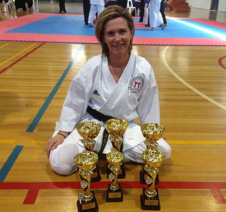 MULTIPLE WINNER: Camperdown's Jill Cole with the bounty of trophies she won at the National All Styles Karate Championships in Melbourne on Sunday.  