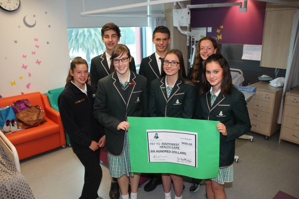 TEAMWORK:Year 10 students from Brauer College with the $600 cheque they raised for the Delta Therapy Dogs program. Their fundraising efforts continue. 