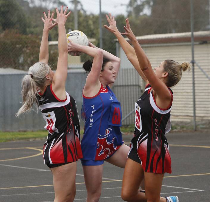 HANDS UP: Koroit's Teagan Lang and Kasey Owen surround Terang Mortlake's Sharni Moloney. The Saints won a thriller at Victoria Park by one goal, climbing to fourth and sending the Bloods back to third. Picture: Aaron Sawall


