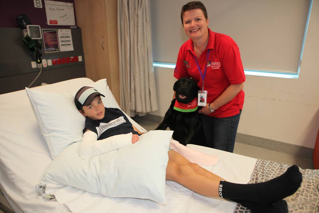 GOOD COMPANY: Finn Tolland gets a visit from Layla and her owner Leonie Guld as part of the Delta Therapy Dogs program at South West Healthcare. Picture: Anthony Brady